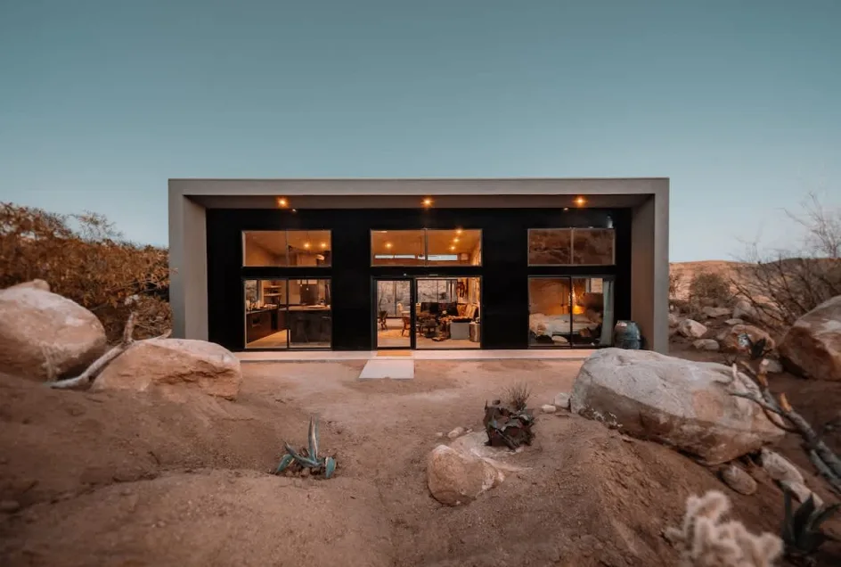 A Cohost desert home glowing at dusk